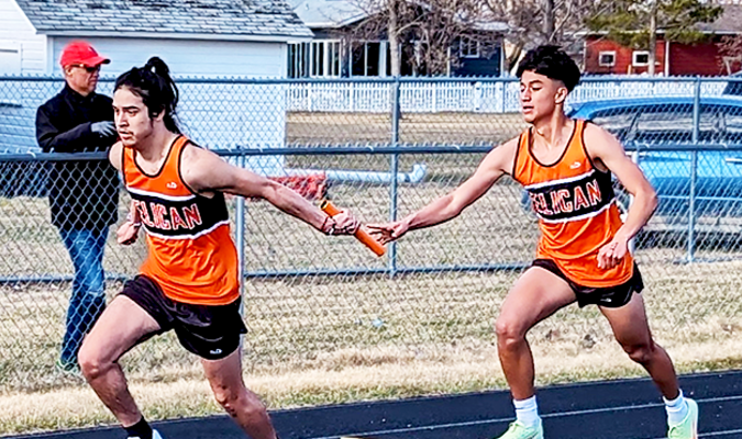 Irvin Villagomez and Angel Garza complete a hand-off in the 4x200 relay.